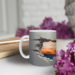 Faux hole design around the sunset center. A personalized sunset mug on a table with a book and flowers. Handmade in Lapeer, Michigan.
